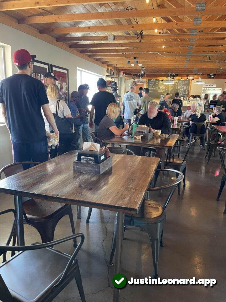 Interior view of Caldwell County BBQ showing line full of people