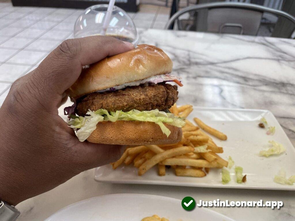 Chik'n sandwich being held by a black male